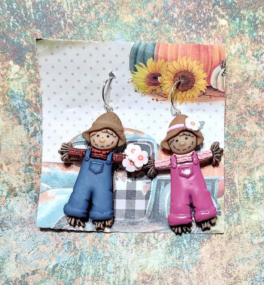 Scarecrow earrings, the scarecrow boy is giving the scarecrow girl flowers