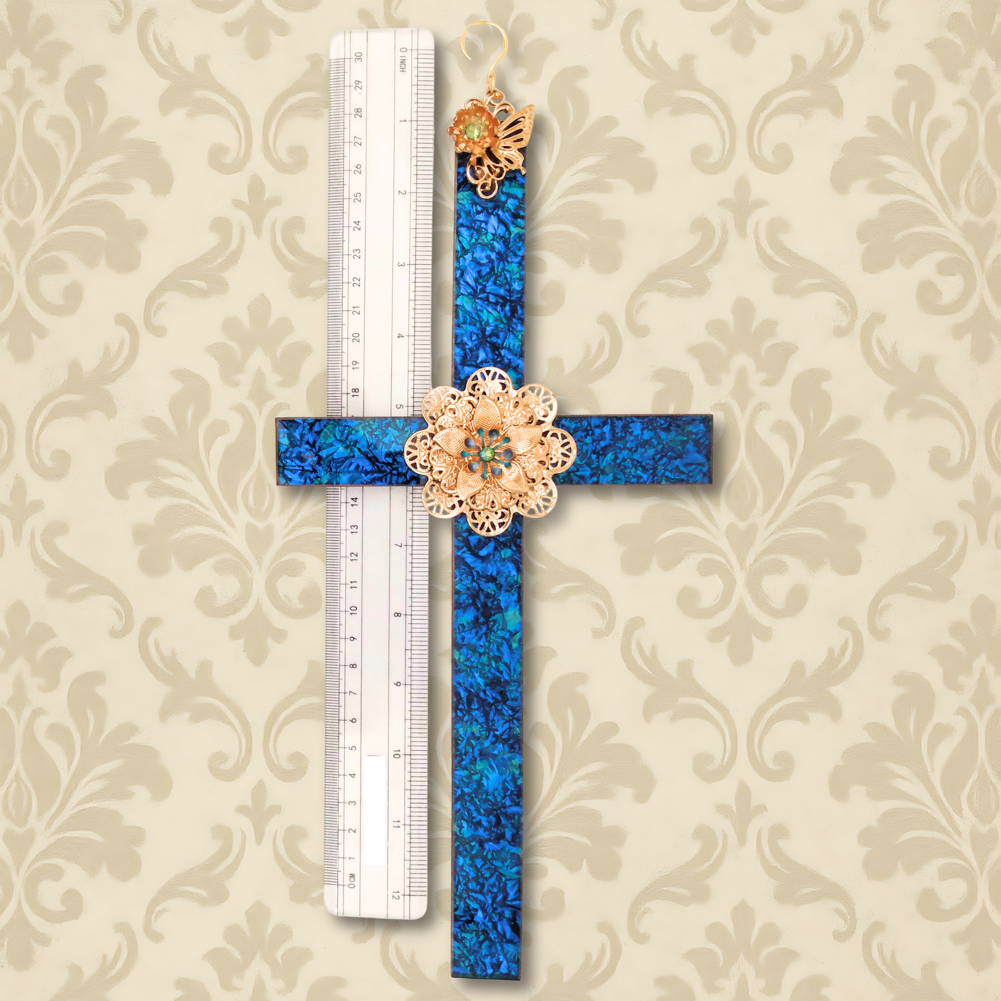 13 inch Van Gogh stained glass wall cross in blue and turquoise glass with gold butterfly and flower handcrafted by Brockus Creations. Shown with ruler to give scale.